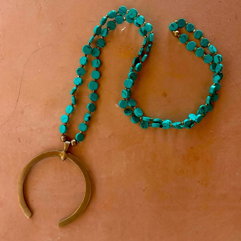 Asha turquoise beaded necklace with large brass pendant.